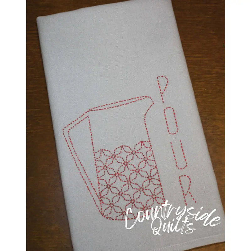 White tea towel with red pitcher design showcasing Sashiko Japanese embroidery by Aunt Martha’s