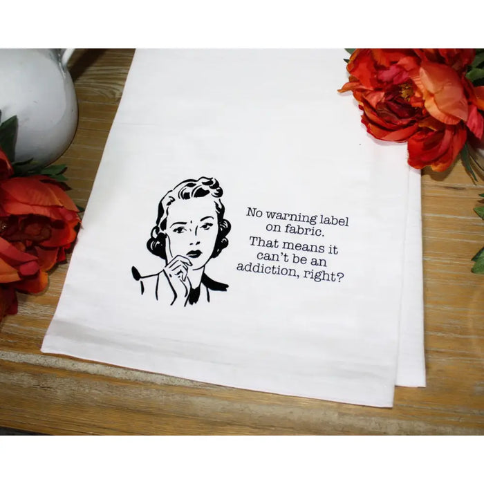 White tea towel featuring retro illustration and humorous washing label text from Aunt Martha’s Dirty Laundry