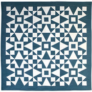 Geometric patterned quilt in teal blue and white from Art East Quilting Propeller Quilt Pattern