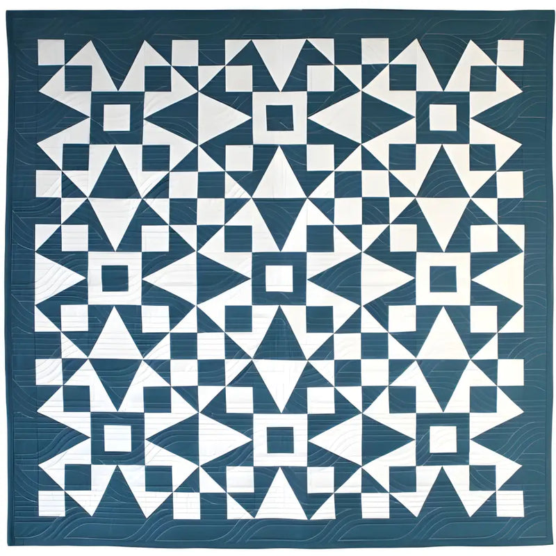 Geometric patterned quilt in teal blue and white from Art East Quilting Propeller Quilt Pattern