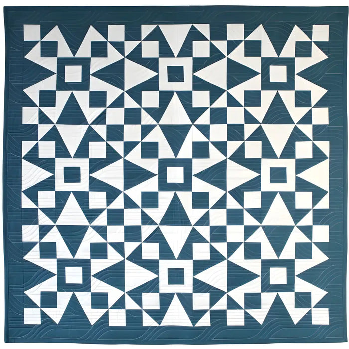 Geometric patterned quilt in teal blue and white from Art East Quilting Propeller Quilt Pattern