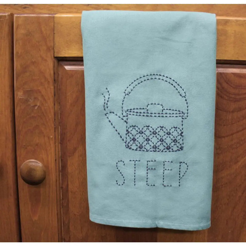Light blue tea towel with a dotted teapot and STEEP, featuring Aunt Martha’s Sashiko Japanese embroidery