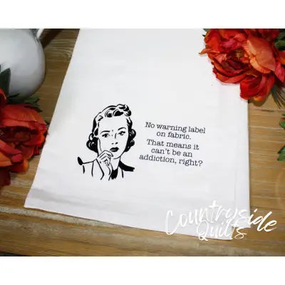 White tea towel featuring retro illustration and humorous washing label text from Aunt Martha’s Dirty Laundry