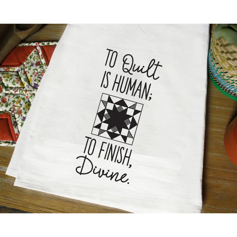 White tea towel with black text and quilting pattern from Aunt Martha’s Dirty Laundry