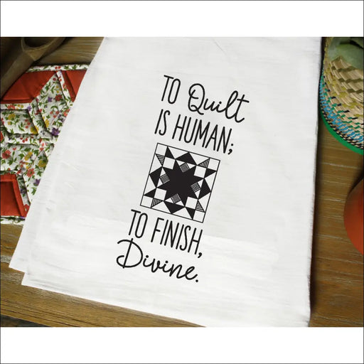 White tea towel with black text and quilting pattern from Aunt Martha’s Dirty Laundry