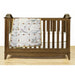 Wooden baby crib with Retro Flower Print blanket, showcasing Aunt Martha’s quilting fabric